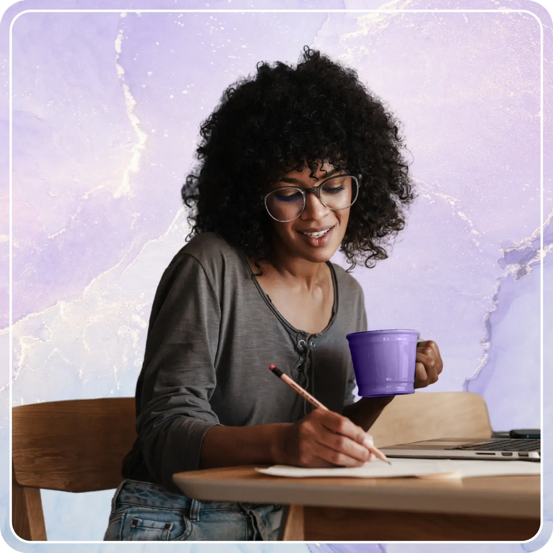 Email Marketing Planning | Woman sitting at desk with purple coffee cup writing a to do list
